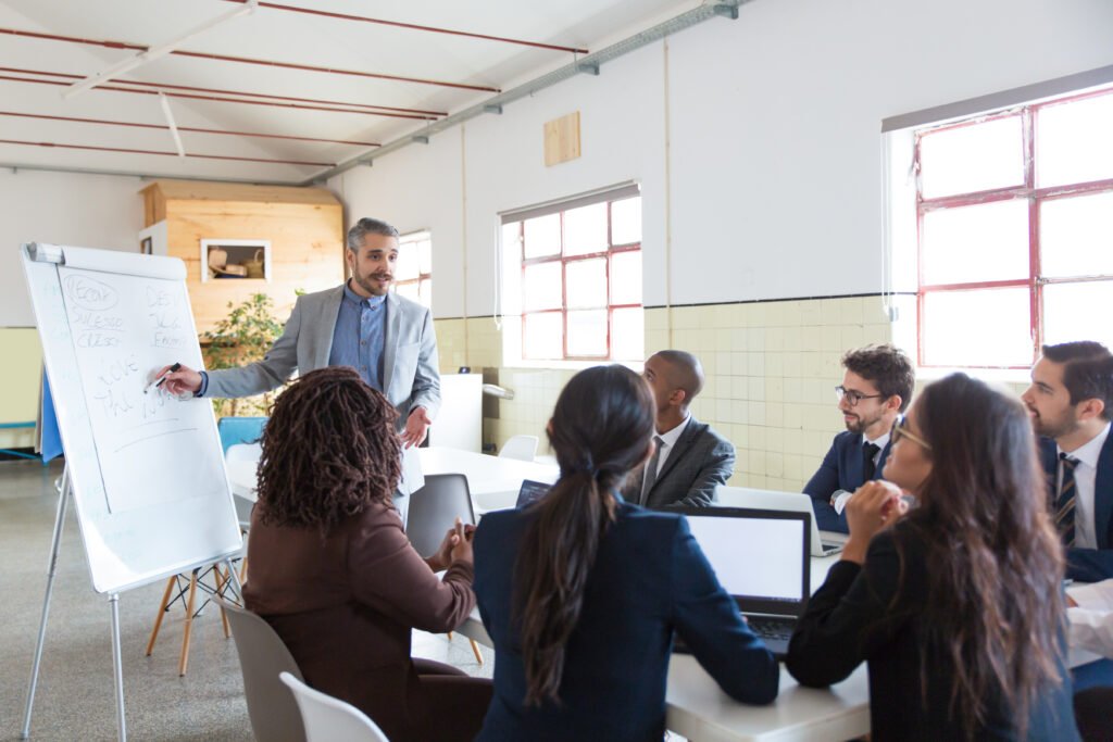 Trainer presenting ideas to employees in a corporate training center in Sector 136 meeting room.