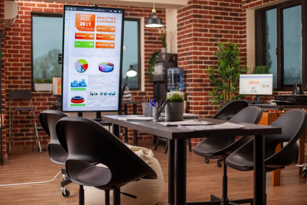 Smart workspace in Sector 136 Noida featuring digital displays and collaborative seating